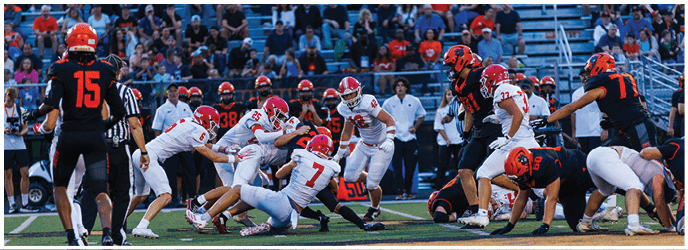 A group of football players on a field. Description generated by AI
