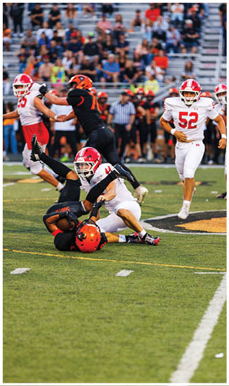 A football player running on the field. Description generated by AI