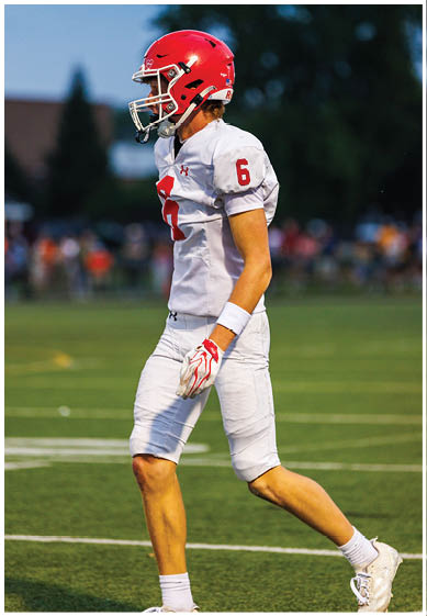 A football player wearing a blue jersey with the number 58 on it. Description generated by AI