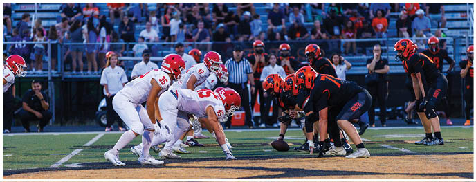 A football player is sliding on the ground. Description generated by AI