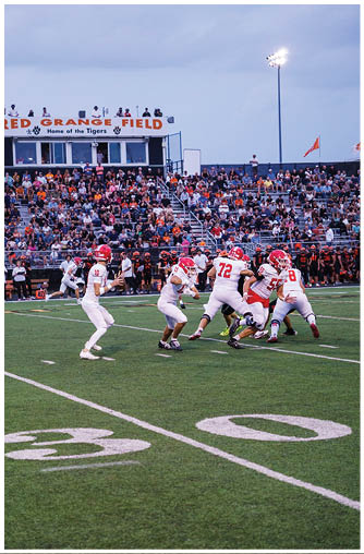 A football player running on the field. Description generated by AI
