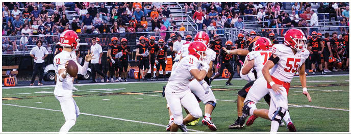 A football player is sliding on the ground. Description generated by AI