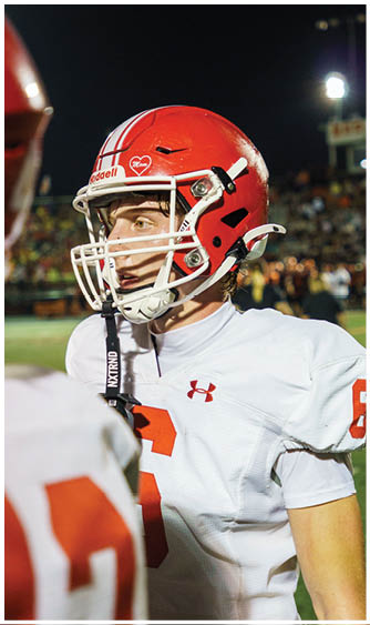 A football player running on the field. Description generated by AI