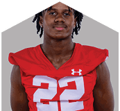 A young man wearing a white jersey with the number 10 on it. Description generated by AI