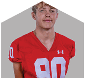 A young man wearing a white jersey with the number 10 on it. Description generated by AI