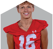 A young man wearing a white jersey with the number 10 on it. Description generated by AI