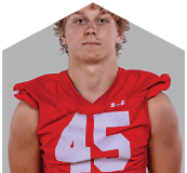 A young man wearing a white jersey with the number 10 on it. Description generated by AI