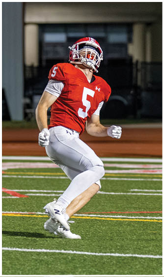A football player running on the field. Description generated by AI