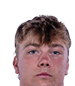 A young man wearing a white jersey with the number 10 on it. Description generated by AI