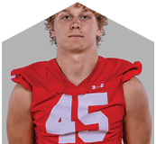 A young man wearing a white jersey with the number 10 on it. Description generated by AI