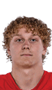 A young man wearing a white jersey with the number 10 on it. Description generated by AI