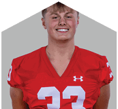 A young man wearing a white jersey with the number 10 on it. Description generated by AI