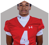 A young man wearing a white jersey with the number 10 on it. Description generated by AI