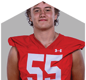 A young man wearing a white jersey with the number 10 on it. Description generated by AI