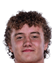 A young man wearing a white jersey with the number 10 on it. Description generated by AI