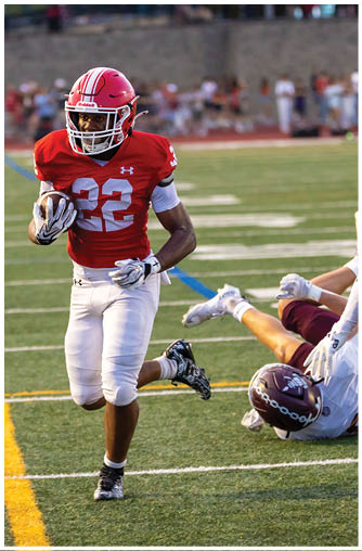 A football player running on the field. Description generated by AI