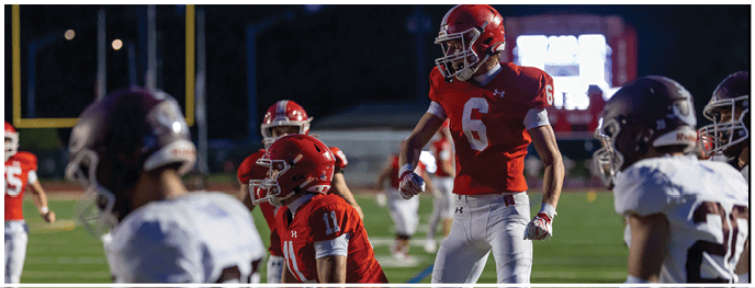 A football player is sliding on the ground. Description generated by AI