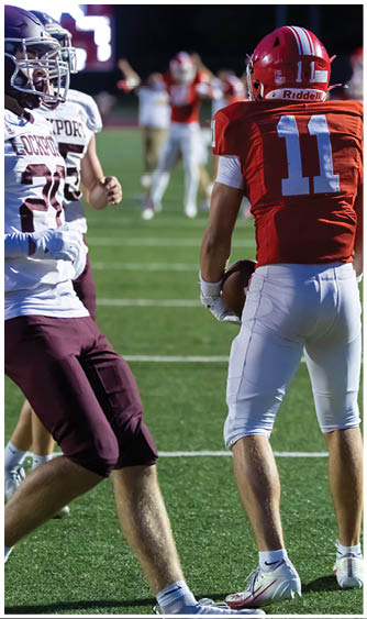 A football player running on the field. Description generated by AI