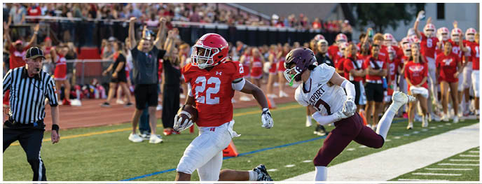 A football player is sliding on the ground. Description generated by AI