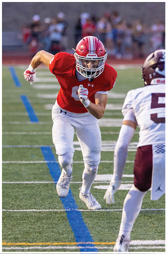 A football player running on the field. Description generated by AI