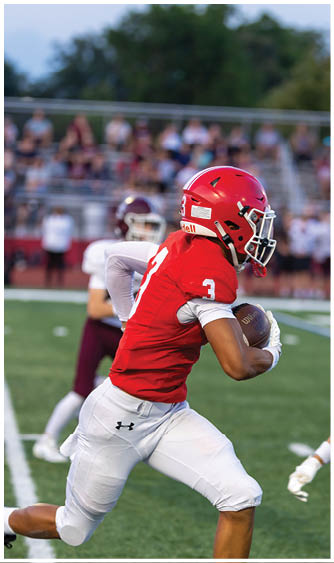 A football player running on the field. Description generated by AI
