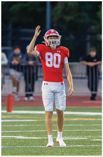 A football player running on the field. Description generated by AI