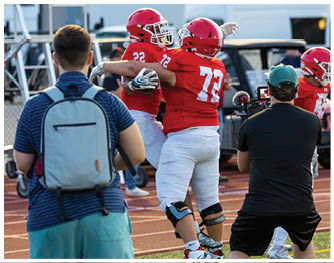 A football player running on the field. Description generated by AI