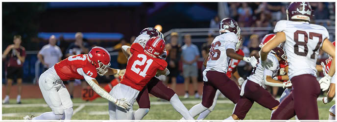 A group of football players on a field. Description generated by AI