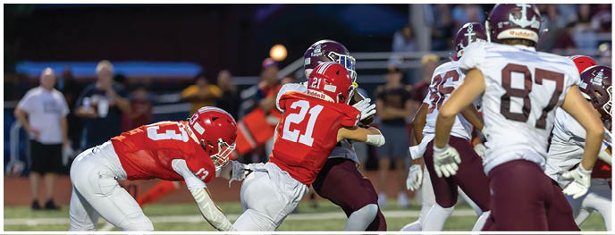 A football player is sliding on the ground. Description generated by AI