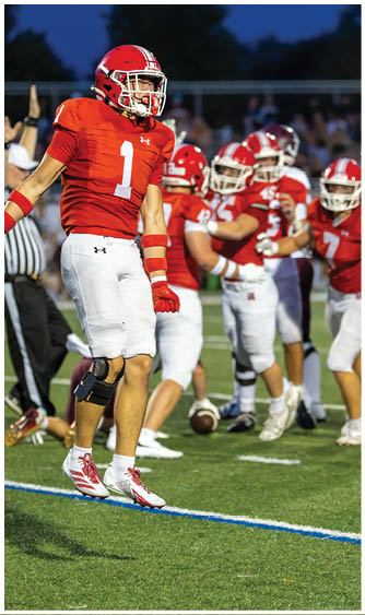 A football player running on the field. Description generated by AI