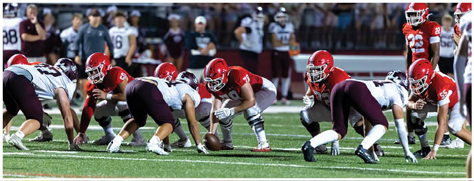 A football player is sliding on the ground. Description generated by AI