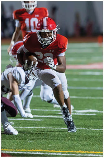 A football player running on the field. Description generated by AI