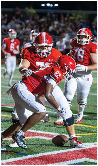 A football player running on the field. Description generated by AI