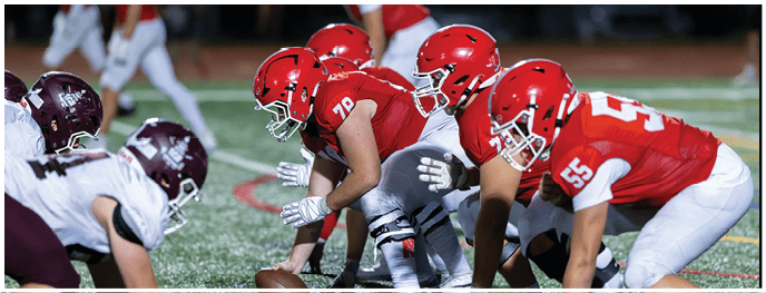 A football player is sliding on the ground. Description generated by AI