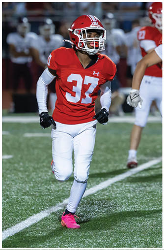 A football player running on the field. Description generated by AI