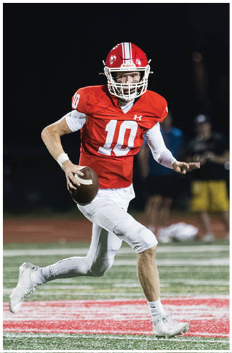 A football player running on the field. Description generated by AI