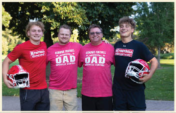A group of football players on a field. Description generated by AI
