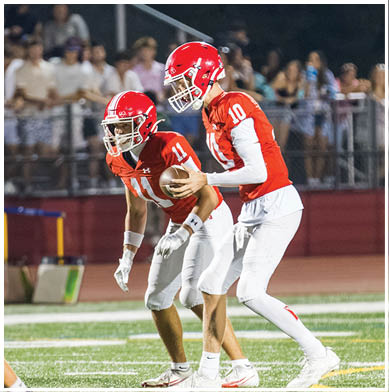 A football player running on the field. Description generated by AI