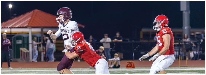 A group of football players on a field. Description generated by AI