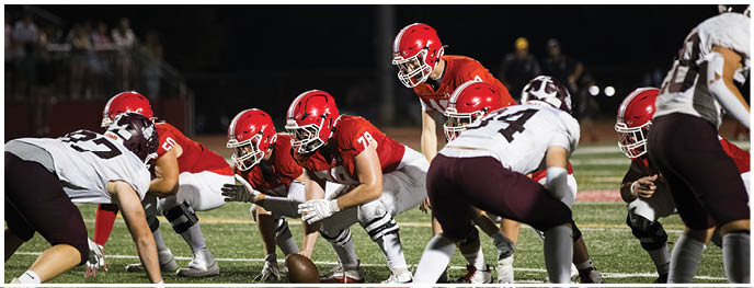 A football player is sliding on the ground. Description generated by AI