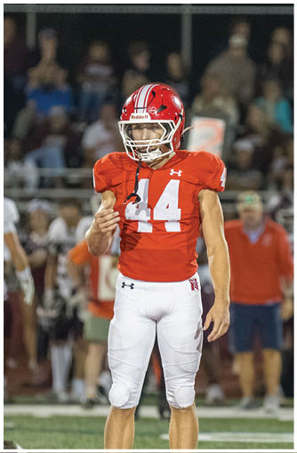 A football player running on the field. Description generated by AI
