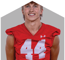 A young man wearing a white jersey with the number 10 on it. Description generated by AI