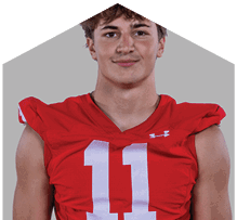 A young man wearing a white jersey with the number 10 on it. Description generated by AI
