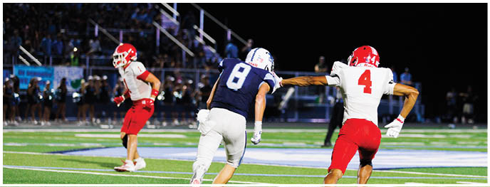 A football player is sliding on the ground. Description generated by AI