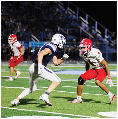 A football player running on the field. Description generated by AI