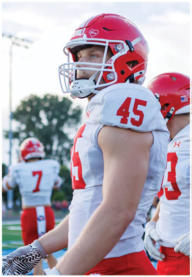 A football player wearing a blue jersey with the number 58 on it. Description generated by AI