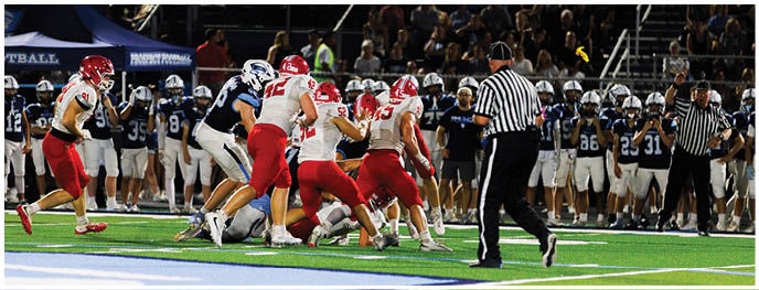 A football player is sliding on the ground. Description generated by AI