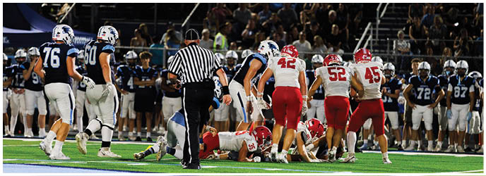 A group of football players on a field. Description generated by AI