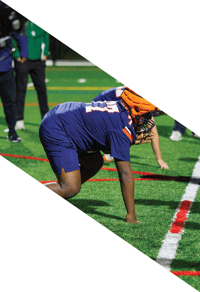 Four football players pose for a picture on the field. AI generated content