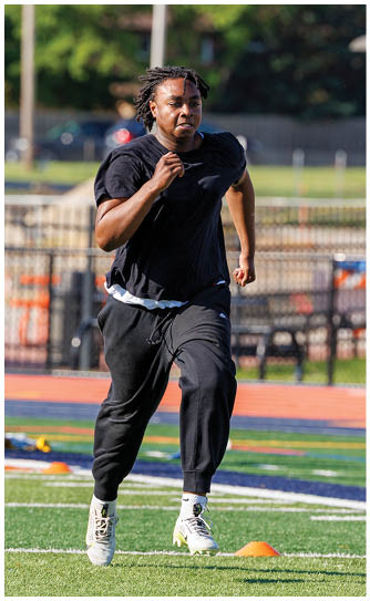 A football player catching a ball. Description generated by AI